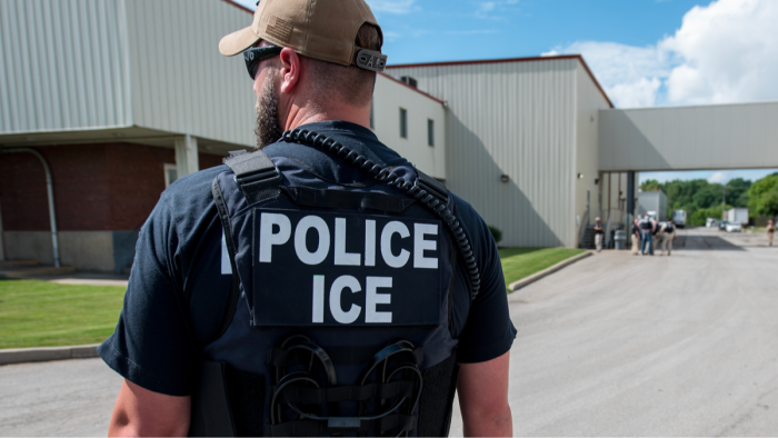 Italian and ICE officials stand with police, discussing security roles during Olympics.