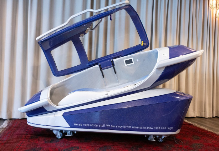 Designer presenting advanced sarco pod features for personal agency and access