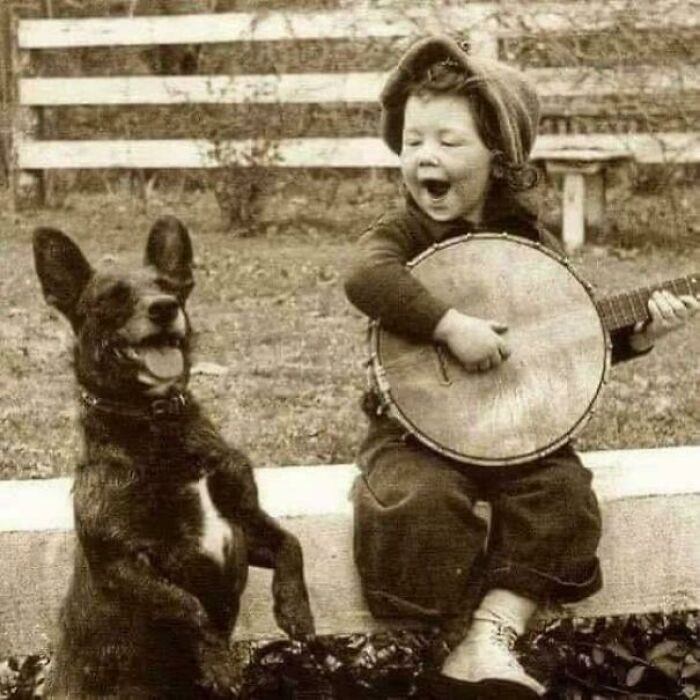 "A Young Boy Playing The Banjo With His Dog, 1920"