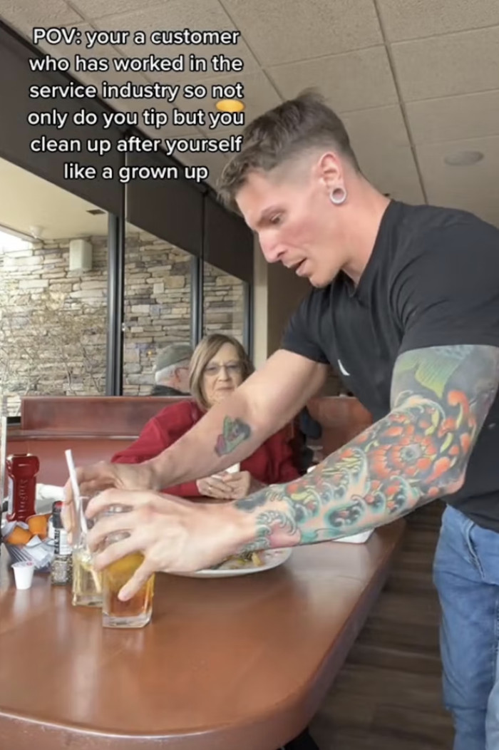 A video was shared by @nicksmostcommonw on TikTok, where he can be seen cleaning up the table for his server. This has led to a discussion on the topics of 