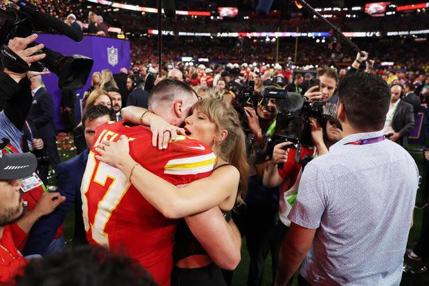 Travis Kelce and Taylor Swift share a hug after the Chiefs clinched victory over the San Francisco 49ers in overtime at Super Bowl LVIII.