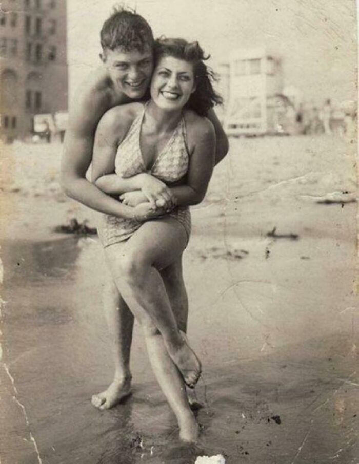 A young couple enjoying a quiet moment on the beach, captured in 1931.