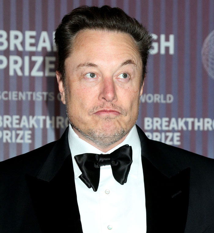Elon Musk’s poker face after declaring himself a time-traveling vampire alien—because why not?