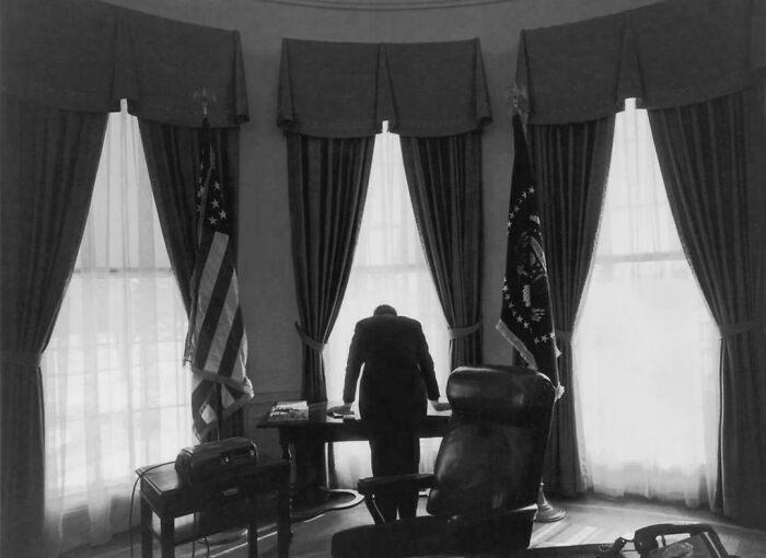 "President John F. Kennedy Leans Over His Desk In This Iconic Photo, Dubbed "The Lonliest Job." February 11, 1961"