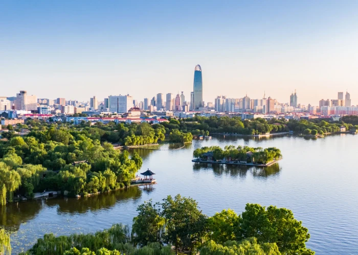 Globetrotter stands in a dim city street, reflecting on travel regrets