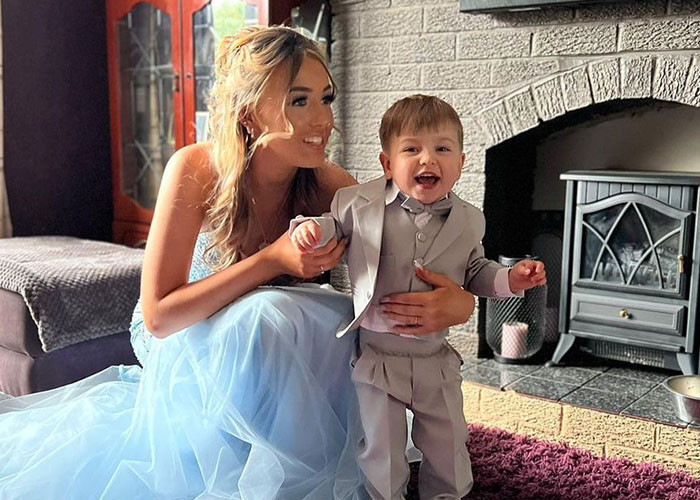 She shared pictures of herself in a light blue, Cinderella-esque gown and her baby in a snazzy gray suit