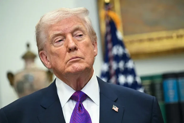 JD Vance speaking at an event, appearing serious and reflective.