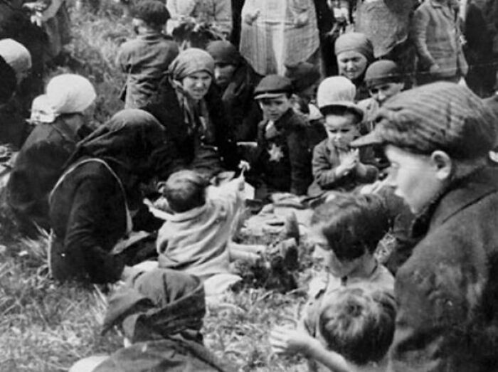 "A Jewish Child Shows Her Friends A Dandelion She Found In The Grass While Waiting Outside The Gas Chambers. Auschwitz-Birkenau, May 1944"