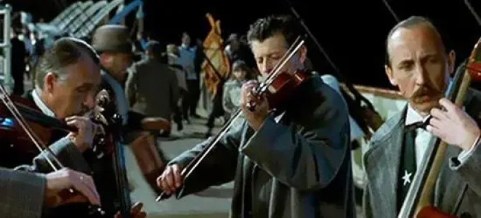 8. When the band accepts their fate and continues playing music in Titanic.