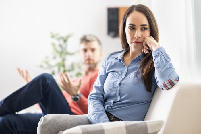 Person looking concerned during relationship discussion, reflecting doubts and potential infidelity signs