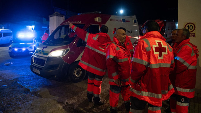 Emergency responders evacuating trapped passengers from derailed train carriage in Spain