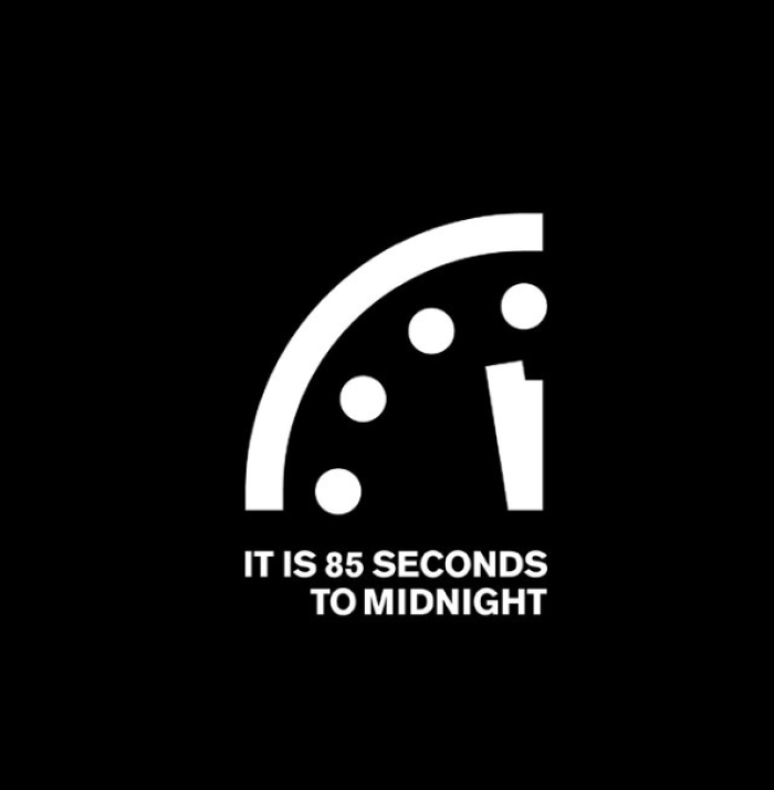 Doomsday Clock face showing time approaching midnight amid global risk headlines