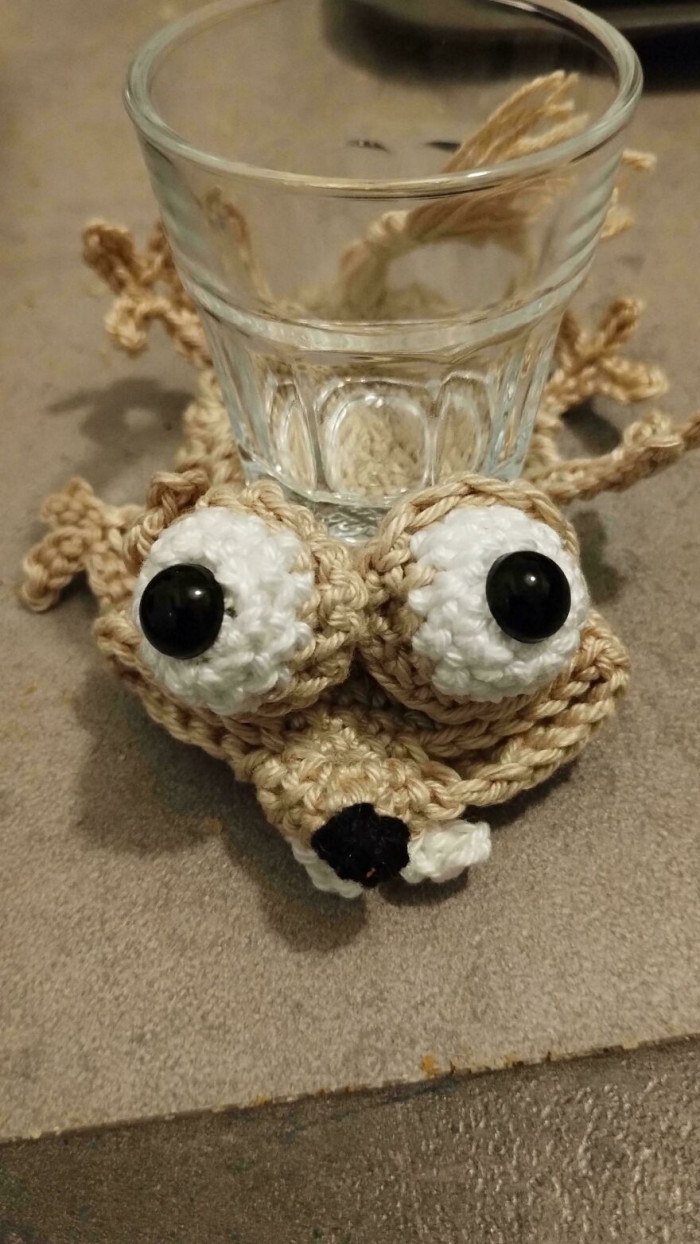 Handmade crochet figure with caption text, featuring a playful child-themed phrase