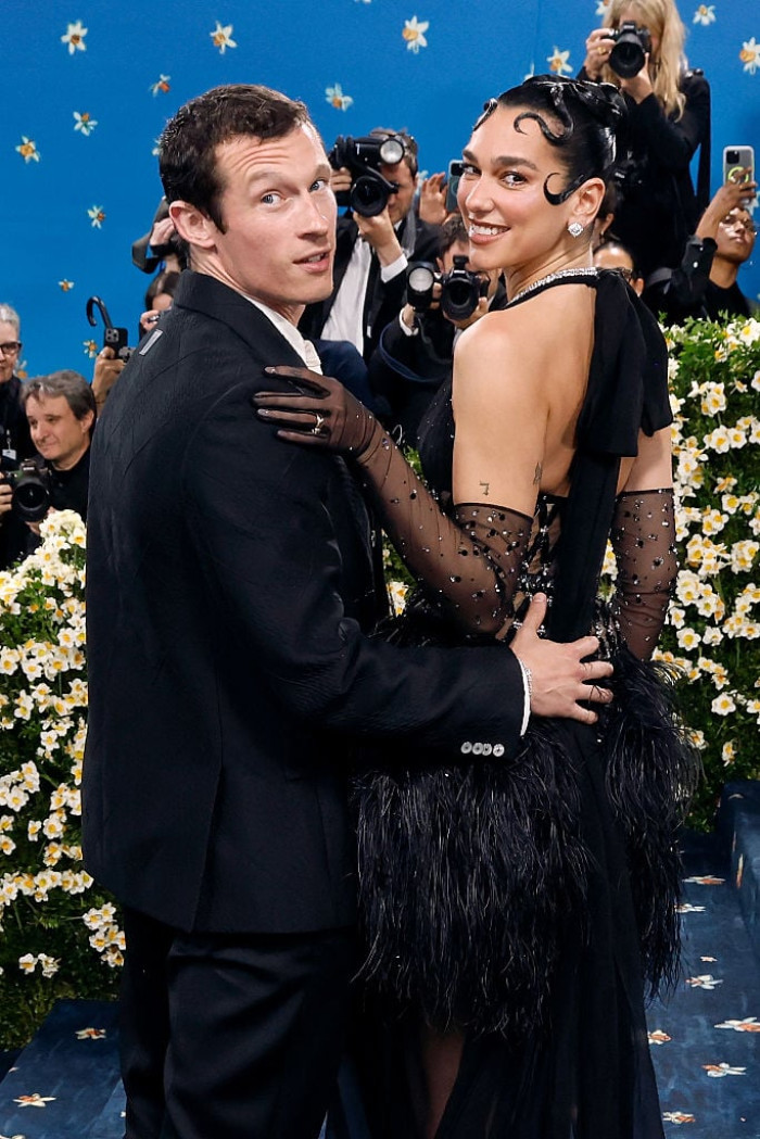 Dua Lipa and Callum Turner confront paparazzi during a chaotic dinner.