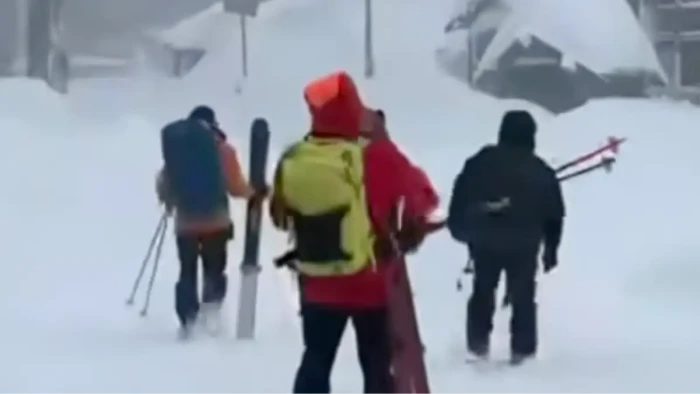 Skiers and avalanche safety warning sign, tour guide scrutiny after missing incident.