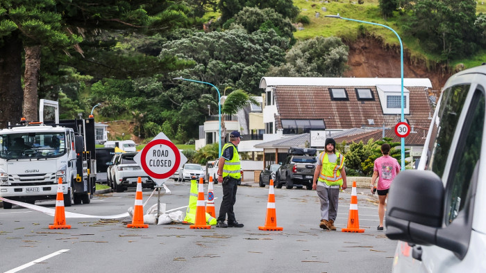 Search and rescue responders with dogs during landslide recovery efforts in severe weather