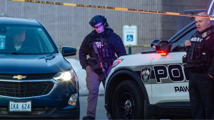 Police and emergency responders near an ice hockey rink after shooting