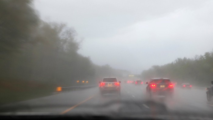 Winter road scene with low visibility, drivers navigating freezing fog warnings