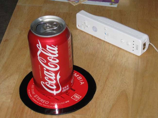 Create drink coasters by cutting vinyl records and sealing them with Mod Podge.