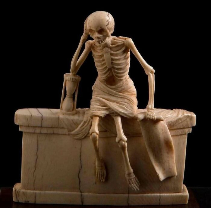 Carved in France in 1547, this ivory sculpture depicts a shrouded skeleton seated on a tomb, hourglass in hand.