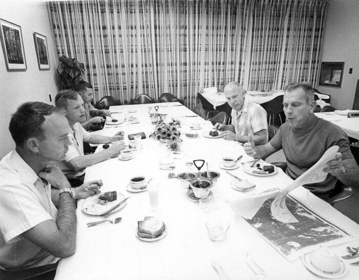 "Apollo 11 Astronauts Review Lunar Charts During Breakfast"