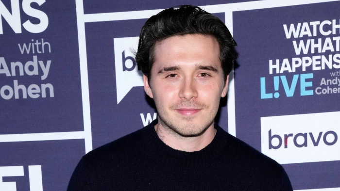 Brooklyn Beckham walking outside after Gordon Ramsay wedding dance comments controversy.