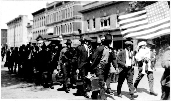 Soldiers march through Kalamazoo, Michigan, during Armistice Day celebrations around 1919, capturing a moment of relief and pride at the end of the First World War.