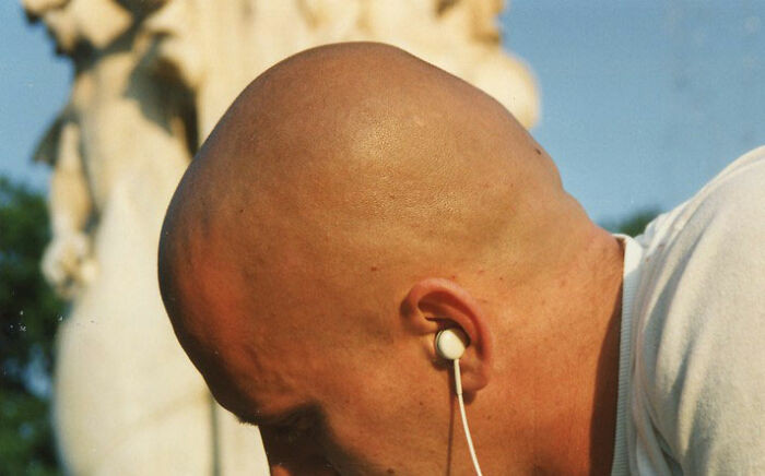 22. For physical appearance: tall, broad-shouldered, and bald.