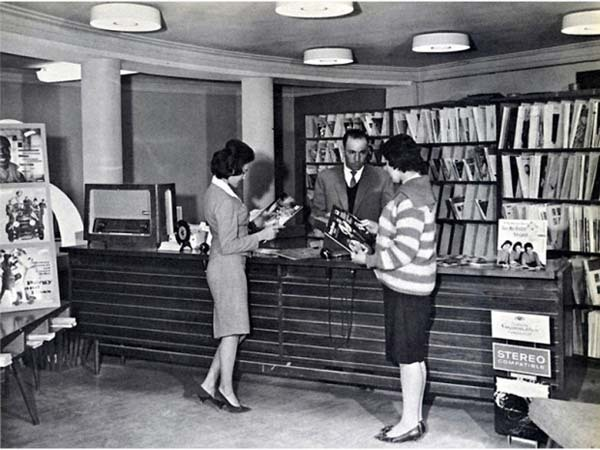 24. Afghan women, casually dressed, use a public library before the Taliban rule (1950s).