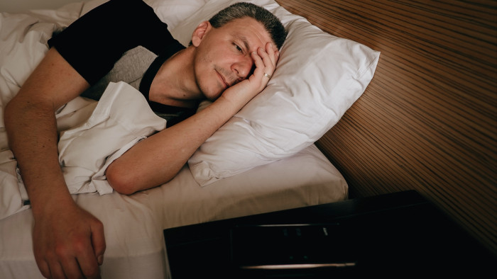 Bedroom setting with alarm clock, nighttime awakenings and sleep apnea awareness context