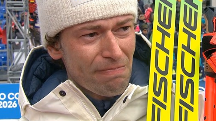 Athlete Lægreid at press conference, microphones nearby, reflecting on infidelity confession