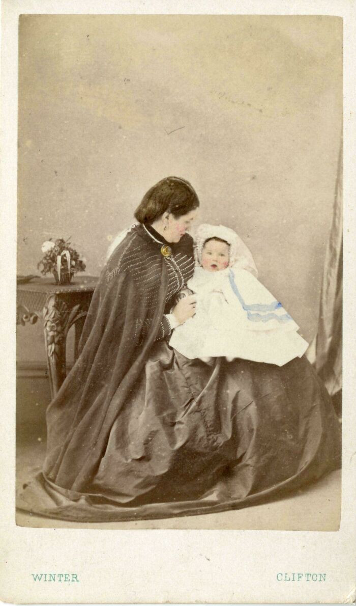 "Hand Coloured Photograph Of A Woman, Agnes-Ann Pascoe Holding A Baby Who Is Her Son, Mydhope Pascoe, 1871"