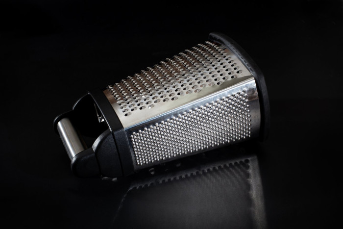 Close-up of a cheese grater showing the fourth grating side