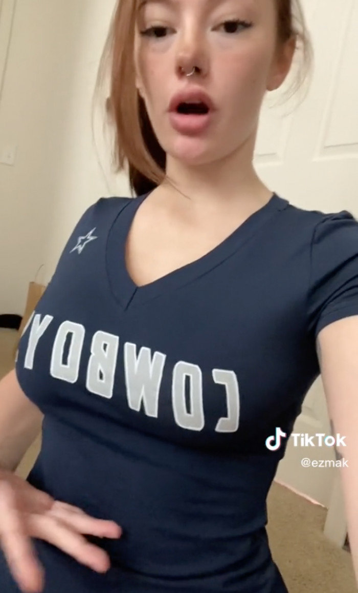 She begins with a standard Dallas Cowboys t-shirt and removes the bottom seam, leaving her with this particular appearance