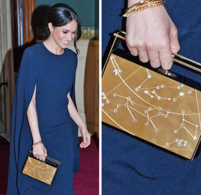 5. Meghan Markle wore a regal cape dress in navy blue by Stella McCartney, paired with a distinctive zodiac clutch by Naeem Khan