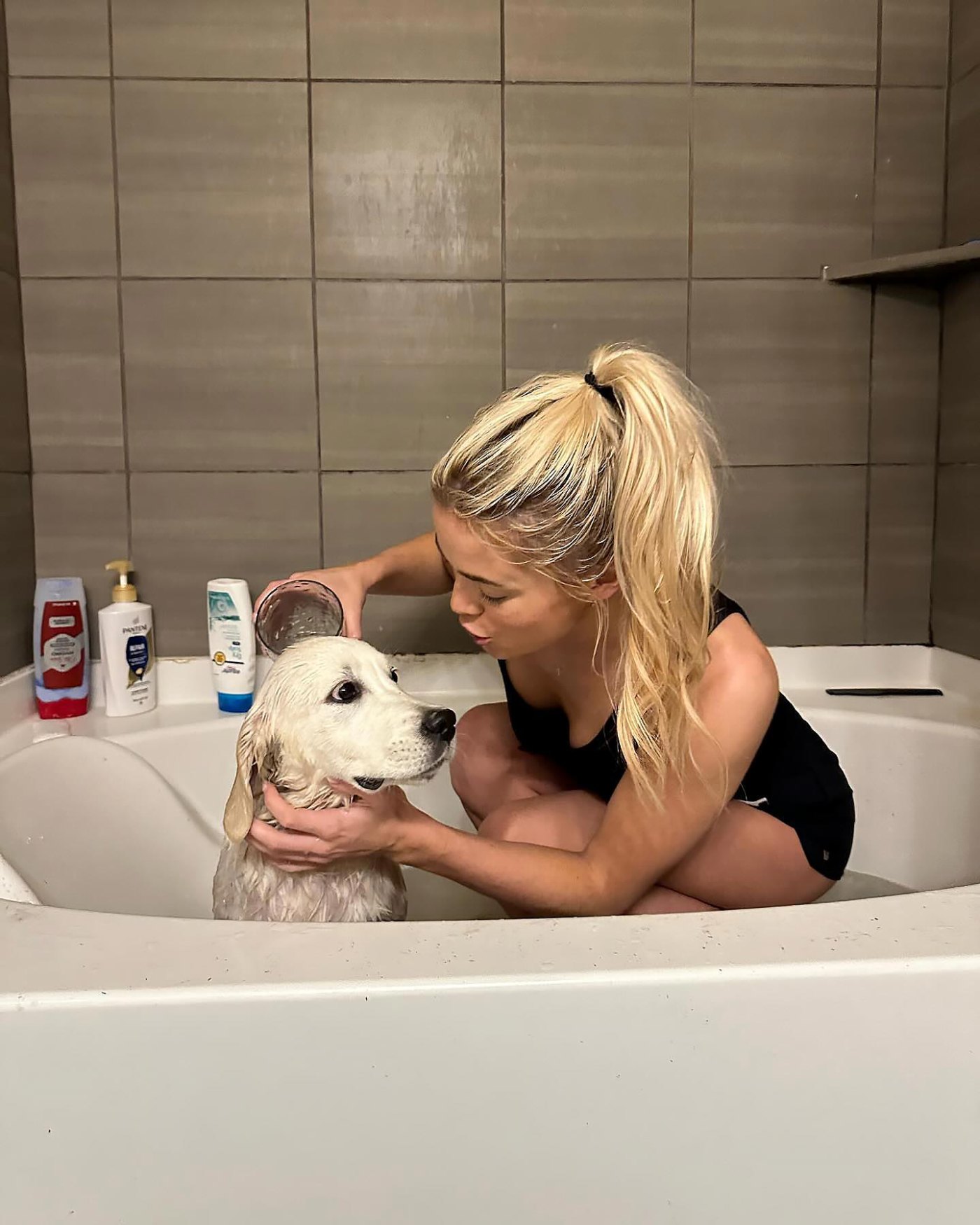 15. Livvy Dunne giving her dog a bath