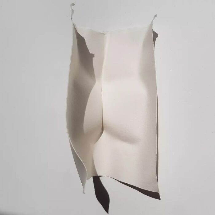 Triangulated repeat paper sculpture, curved zigzag slots forming a new artistic language.