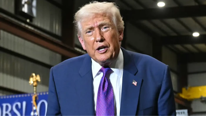 Donald Trump speaking at a public event, eyebrows raised amid heaven remark debate