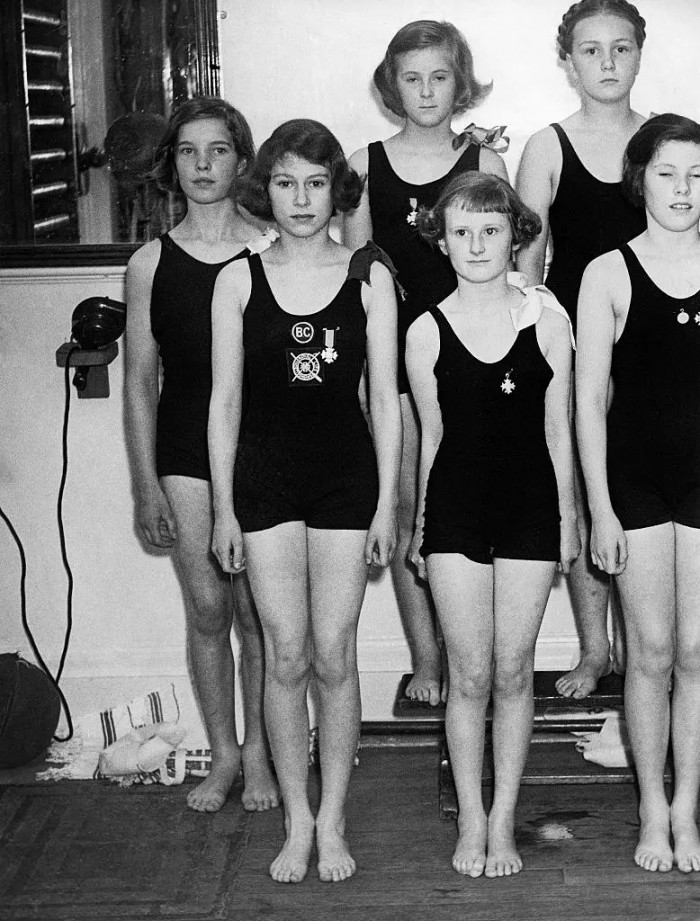 7. Standing beside her swimming team at the Bath Club