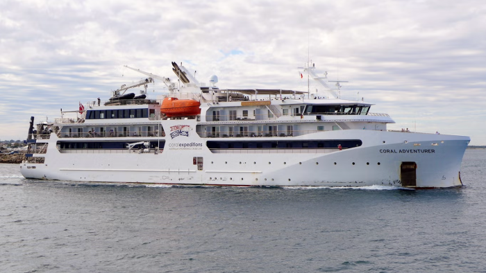 Investigators and officials near a remote island, cruise passenger disappearance inquiry underway