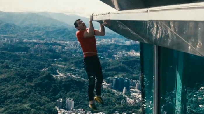 Alex Honnold climbing Taipei 101, rope-free technique emphasizing extreme sports daring.