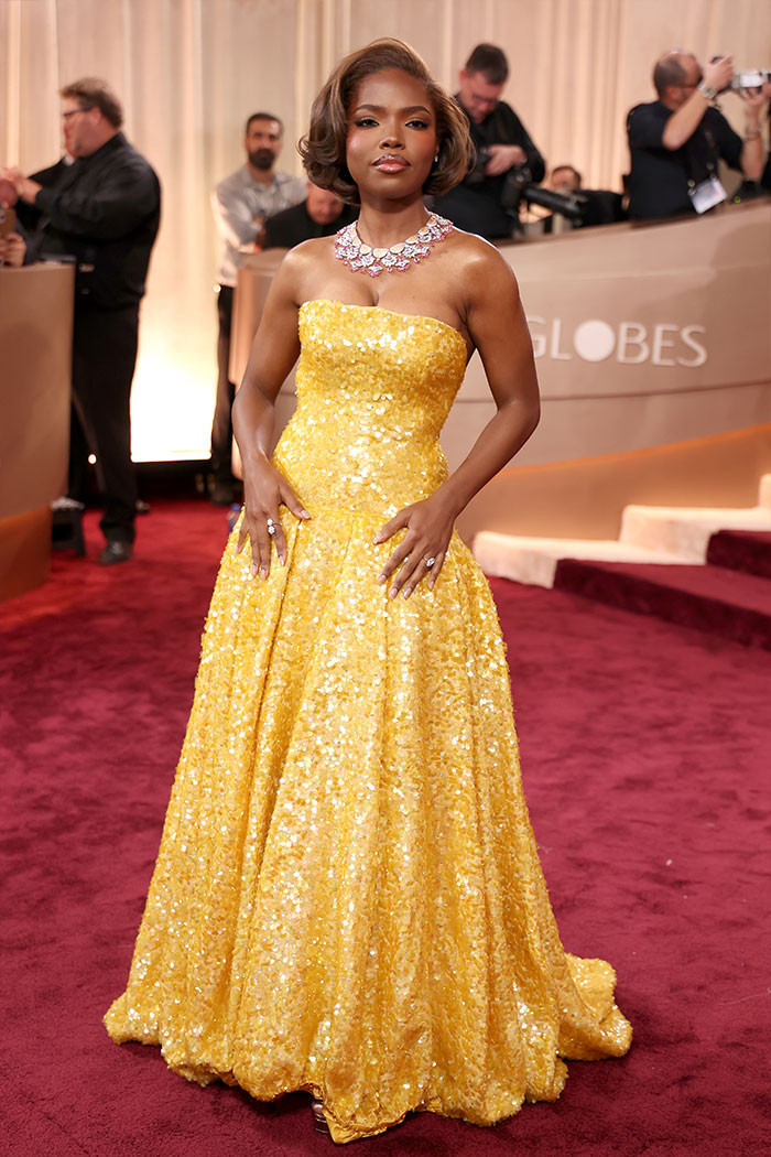 Ryan Destiny - The star stunned in a strapless yellow gown with a corseted bodice and flowing tiered skirt, paired with Chopard pink gemstone jewelry and a sleek bob.