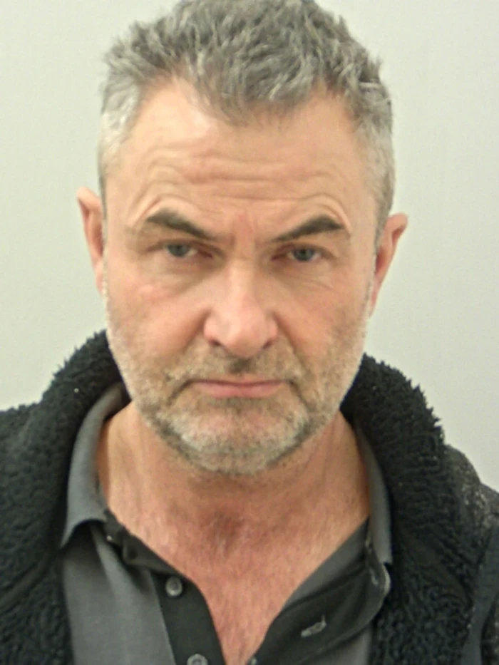 Woman in wheelchair speaking with supporters, sharing survival and advocacy story.