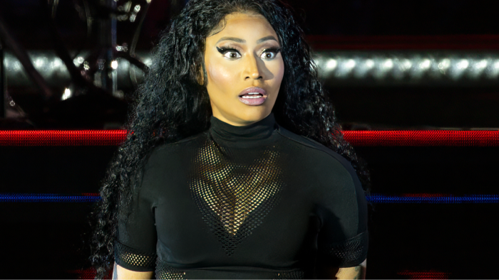 Nicki Minaj posing for photographers, amid fans’ deportation calls online.