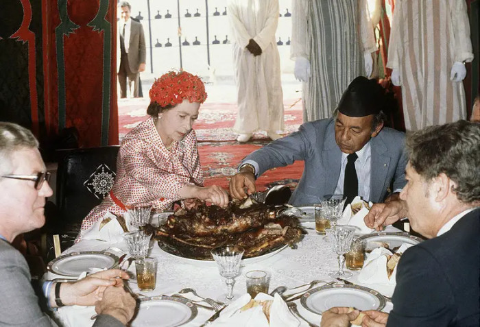 21. Eating with her hands while sharing a meal with King Hassan during a visit to Morocco