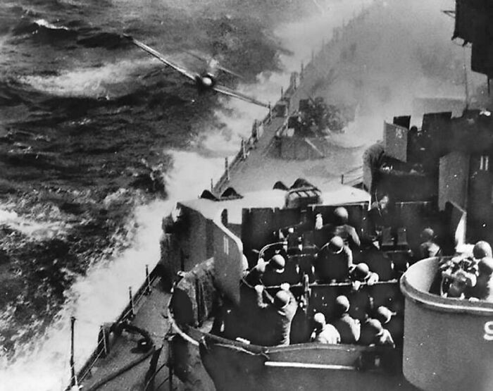 "Okinawa, Japan. April 1945. A Kamikaze Pilot of a Japanese Zero Aircraft Plunges His Plane at the Deck of USS Missouri. The Plane Ricocheted Away, Causing Only Minor Damage, but the Pilot Was Catapulted from the Cockpit, and His Body Demolished Part of a Gun Mount."