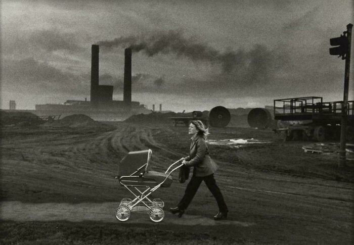 Woman With Pram Strolls Past The Local Steel Works. Consett, UK (1974)