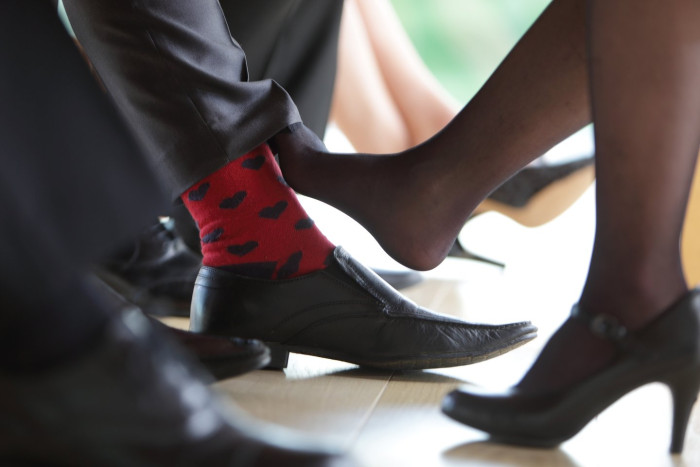 Office workers in a modern workspace discussing workplace romance and boundaries