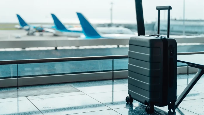 Bright colorful suitcases in an airport, security advice about easy identification