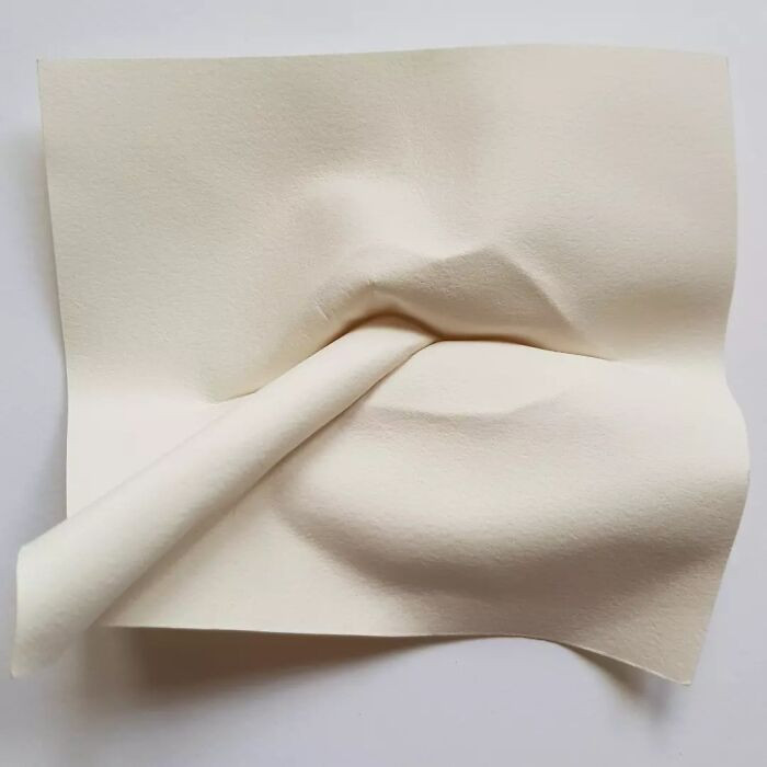 "Face Emerging From The Paper"